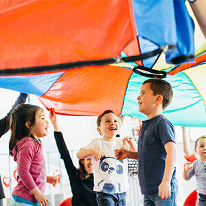 young children under a parachute